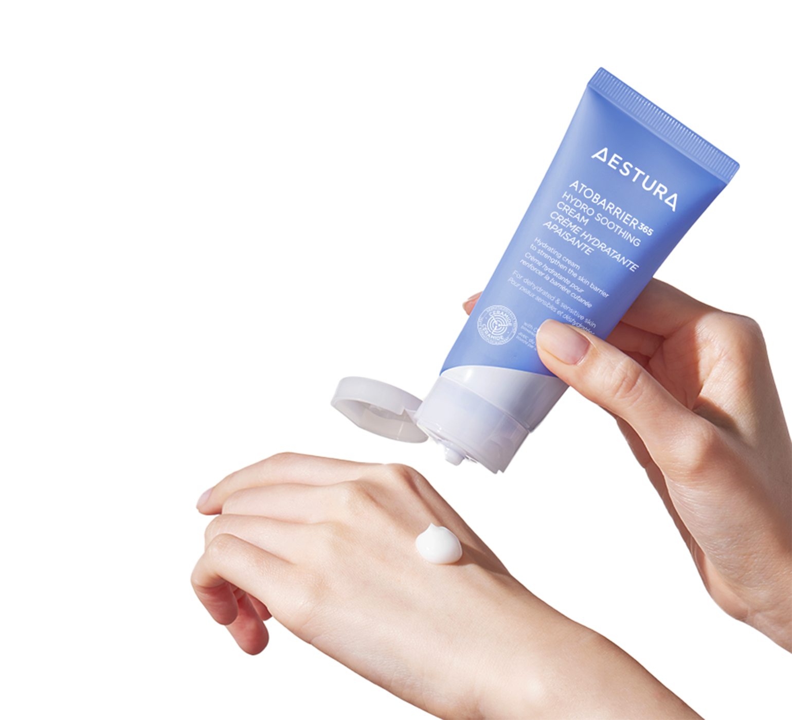 Applying Aestura Hydro Soothing Cream onto the back of a hand, demonstrating texture and application